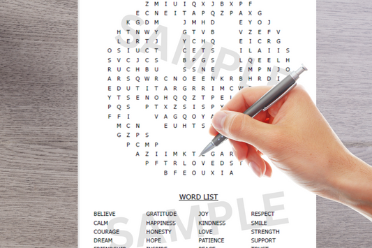 Hand holding a pen over a word search puzzle with a wooden surface.