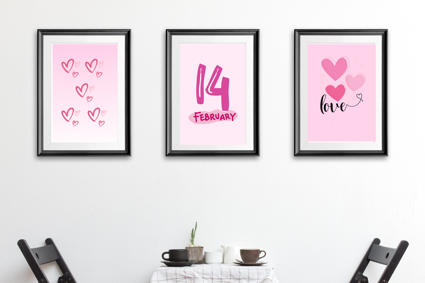 Minimalist desk space with Valentines day wall downloadable prints with pink hearts accents hanging on the wall above.