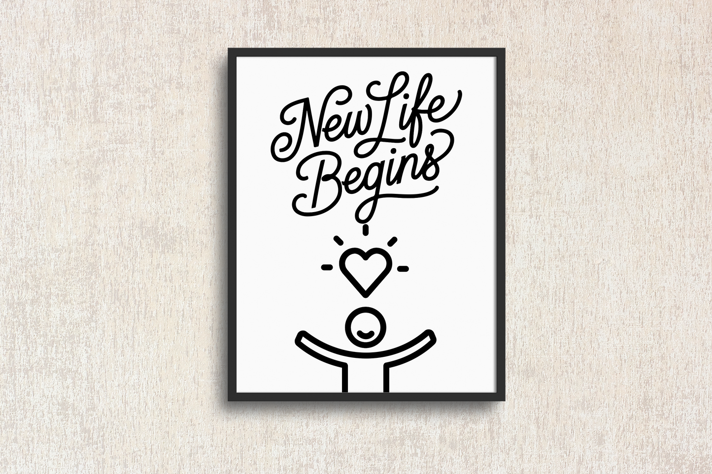 Framed artwork with 'New Life Begins' text and heart symbol on a textured wall.