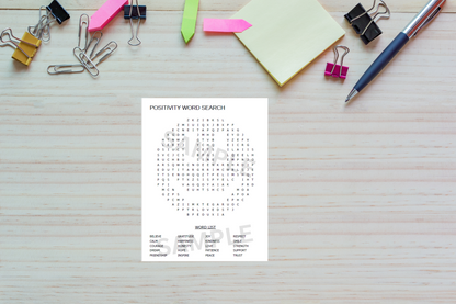 Positivity-themed printable activity sheet laid out on a wooden desk with office supplies