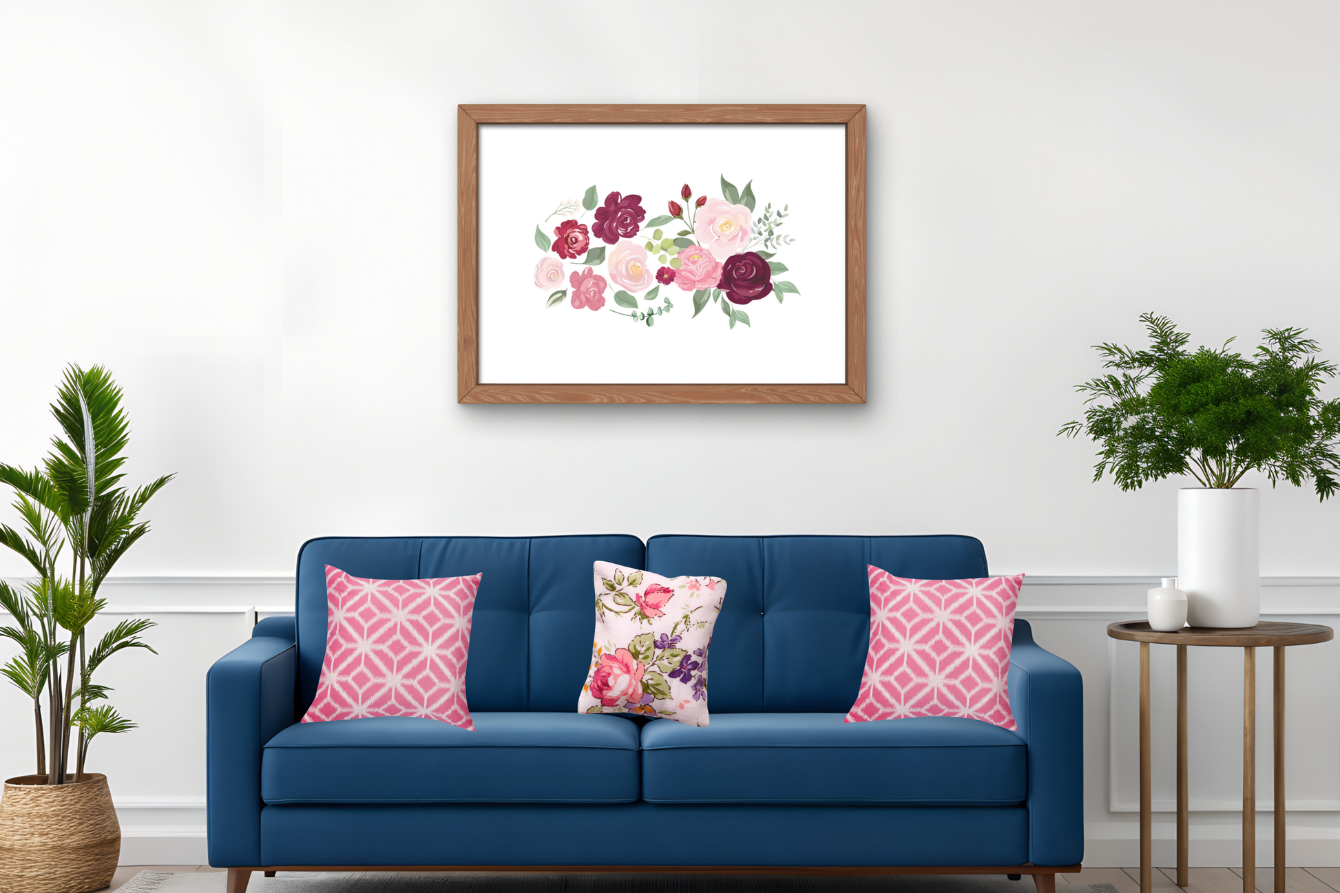 The floral wall art print featuring soft pink and burgundy roses with green foliage, framed in white and styled above a neutral sofa to add elegance and warmth to the living room.
