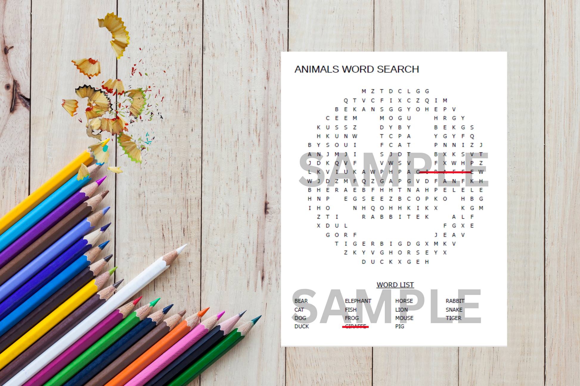 Animals word search sheet with colored pencils on a wooden surface