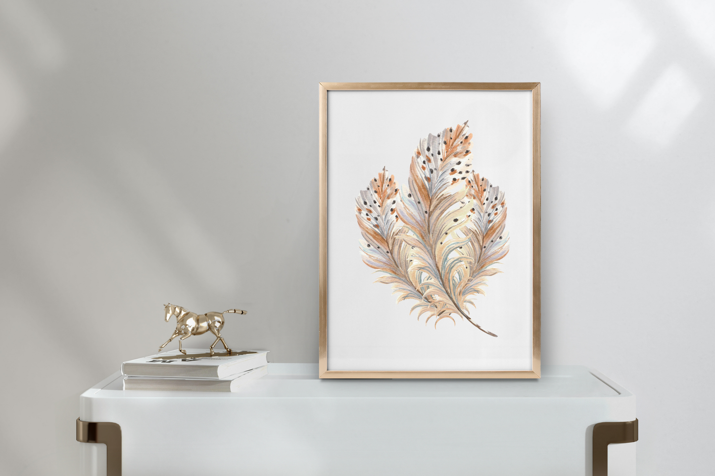 Home office wall decor mock-up with boho feather printable wall art positioned above a table in a minimalist, nature-inspired workspace