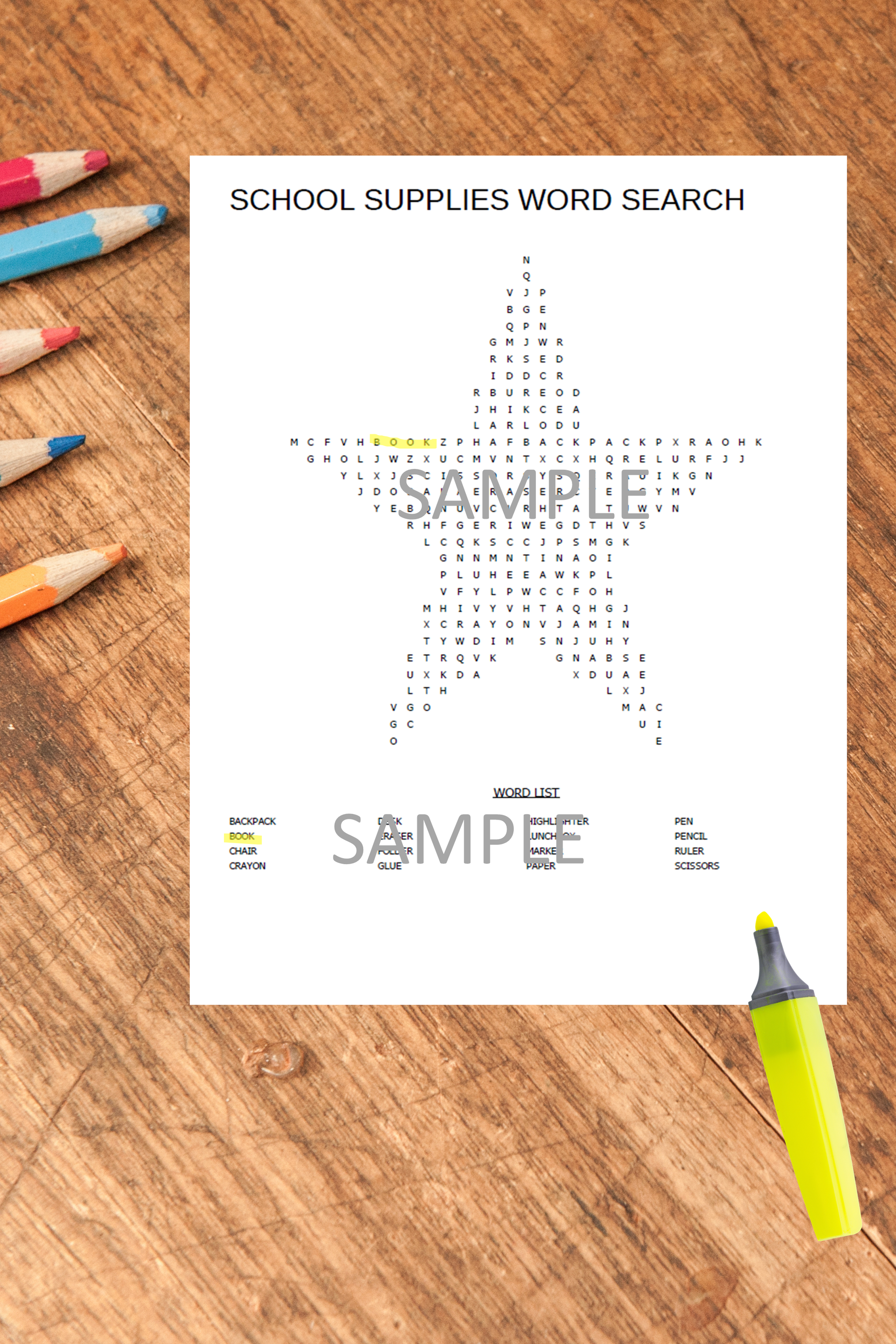 Kids printable puzzle activity sheet displayed on a wooden home table with coloured pens and notebooks.