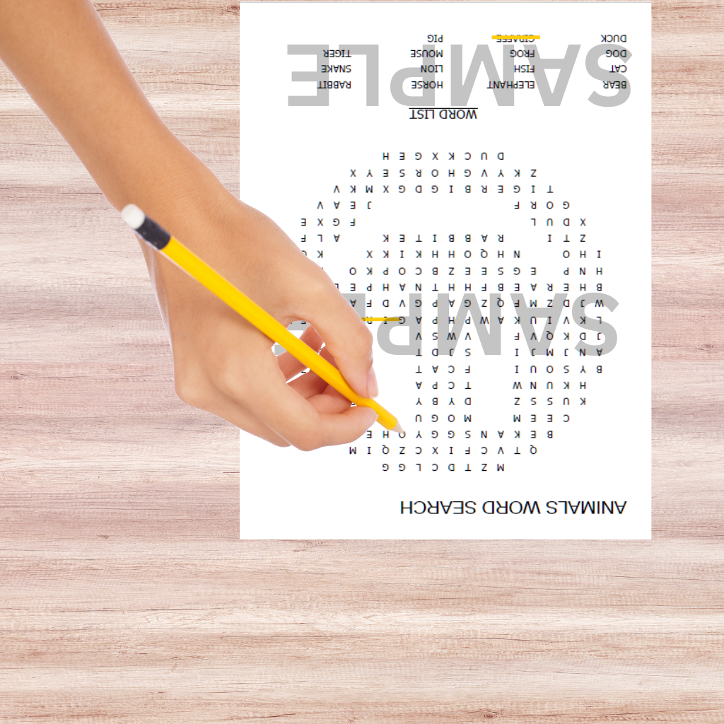 Printable animal word search puzzle sheet on a wooden office desk with a pencil in  child's hand

