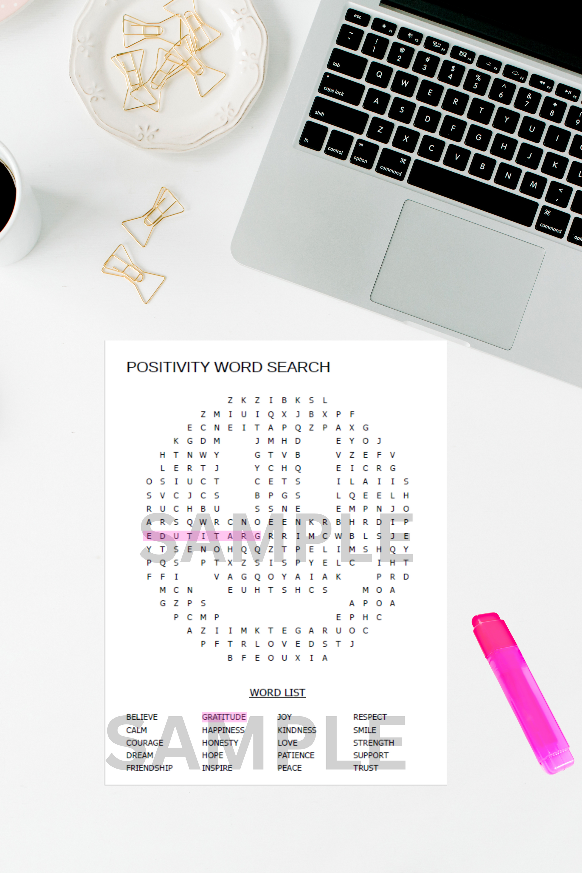 Printable word search puzzle for adults placed on a tidy office desk with a laptop, highlighter pen, and coffee cup.

