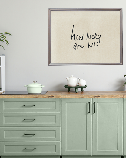 Neutral handwritten typography art print framed above a modern console table