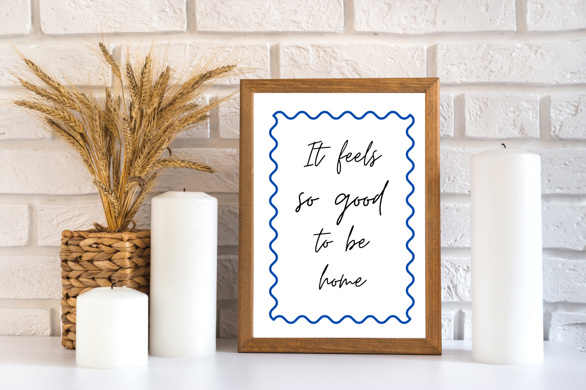 Minimalist printable wall art with soft life quote in blue, placed in a cosy relaxation space with candles and touches of contemporary home vibes.