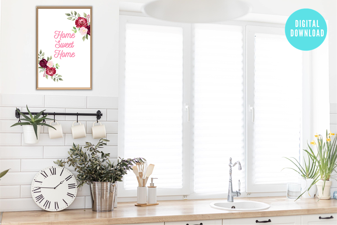 Modern kitchen interior with a 'Home Sweet Home' decorative print, clock, and plants.