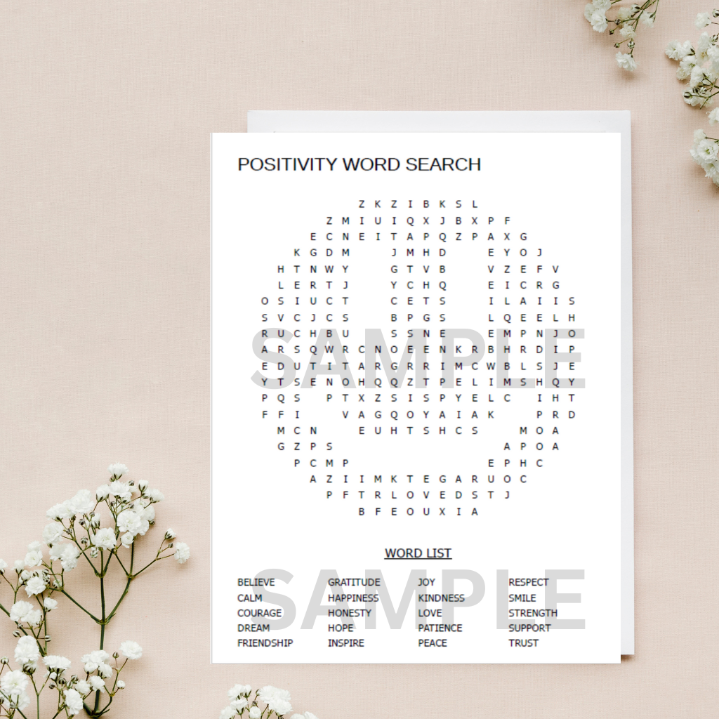 Mindfulness  Positivity word game printable placed on a home beige surface with flowers