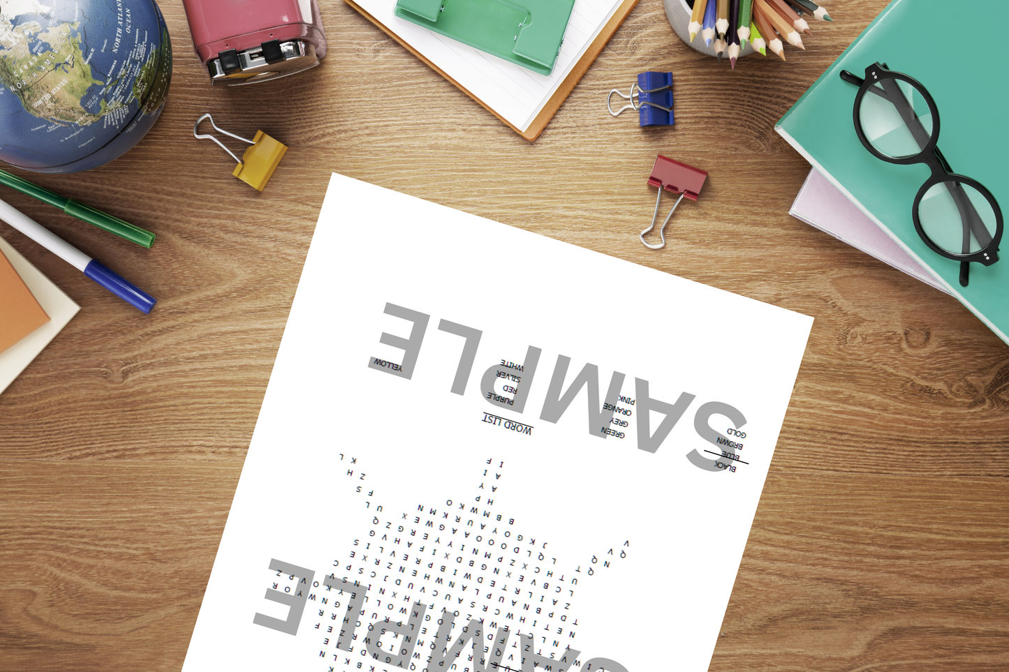 Printable colour-themed word search puzzle on a home office table beside stationery.